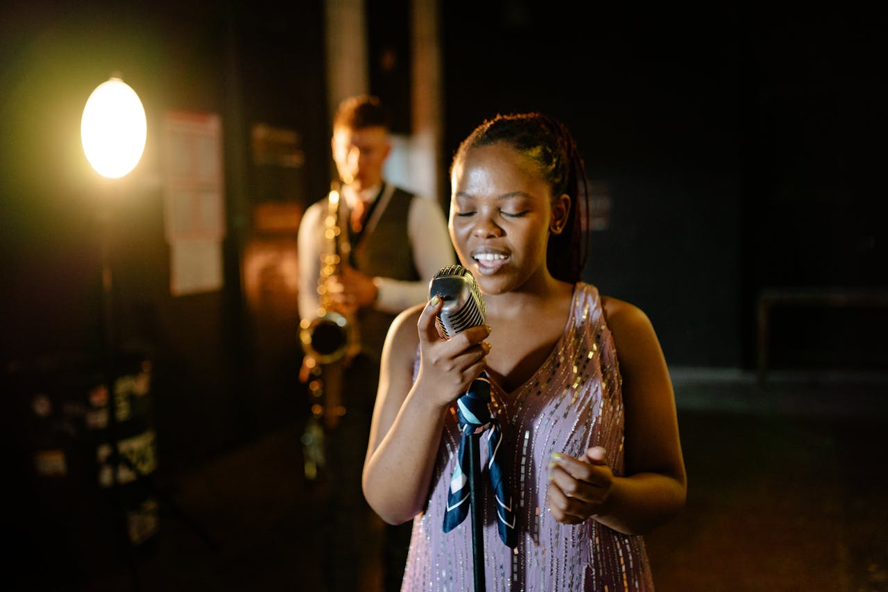 A captivating jazz performance featuring a female singer and saxophonist on stage under warm spotlight.